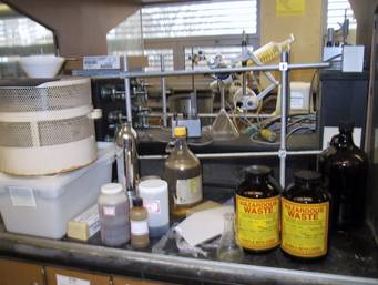 Photo of hazardous waste and other potentially harmful items left at lab station