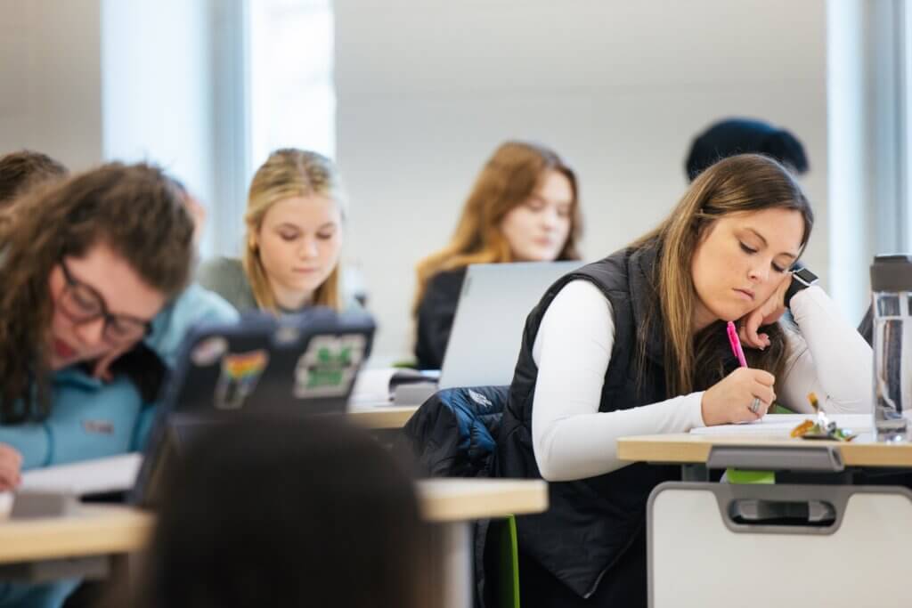 students working and taking notes in class