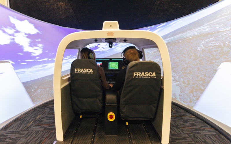 Students in Marshall University's Bill Noe Flight School use a flight simulator to practice flying