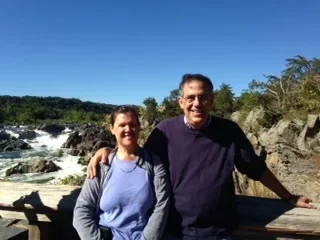 Scott and Phyllis Badesch outside at a waterfall