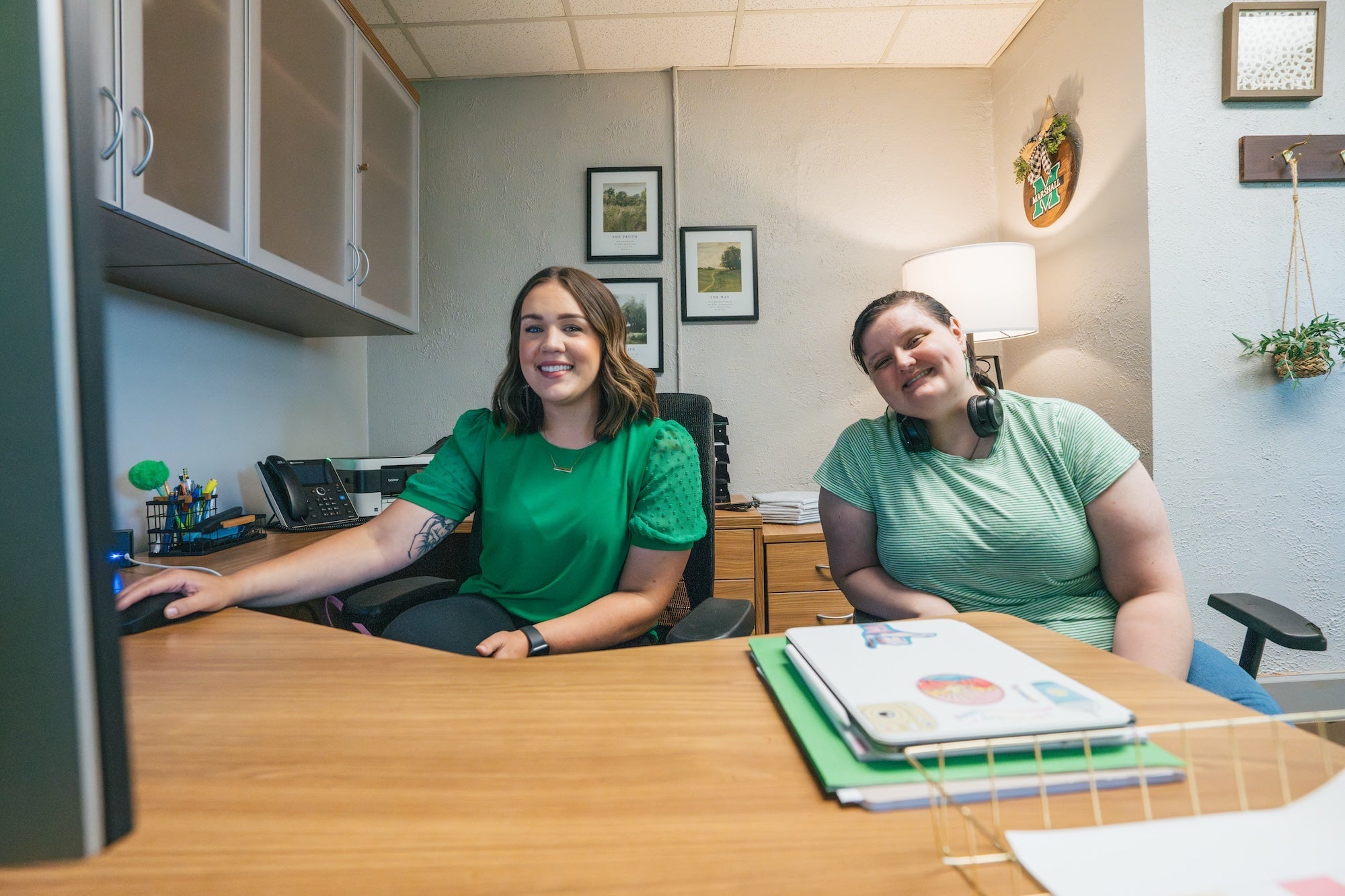 student working with a staff member at a desk