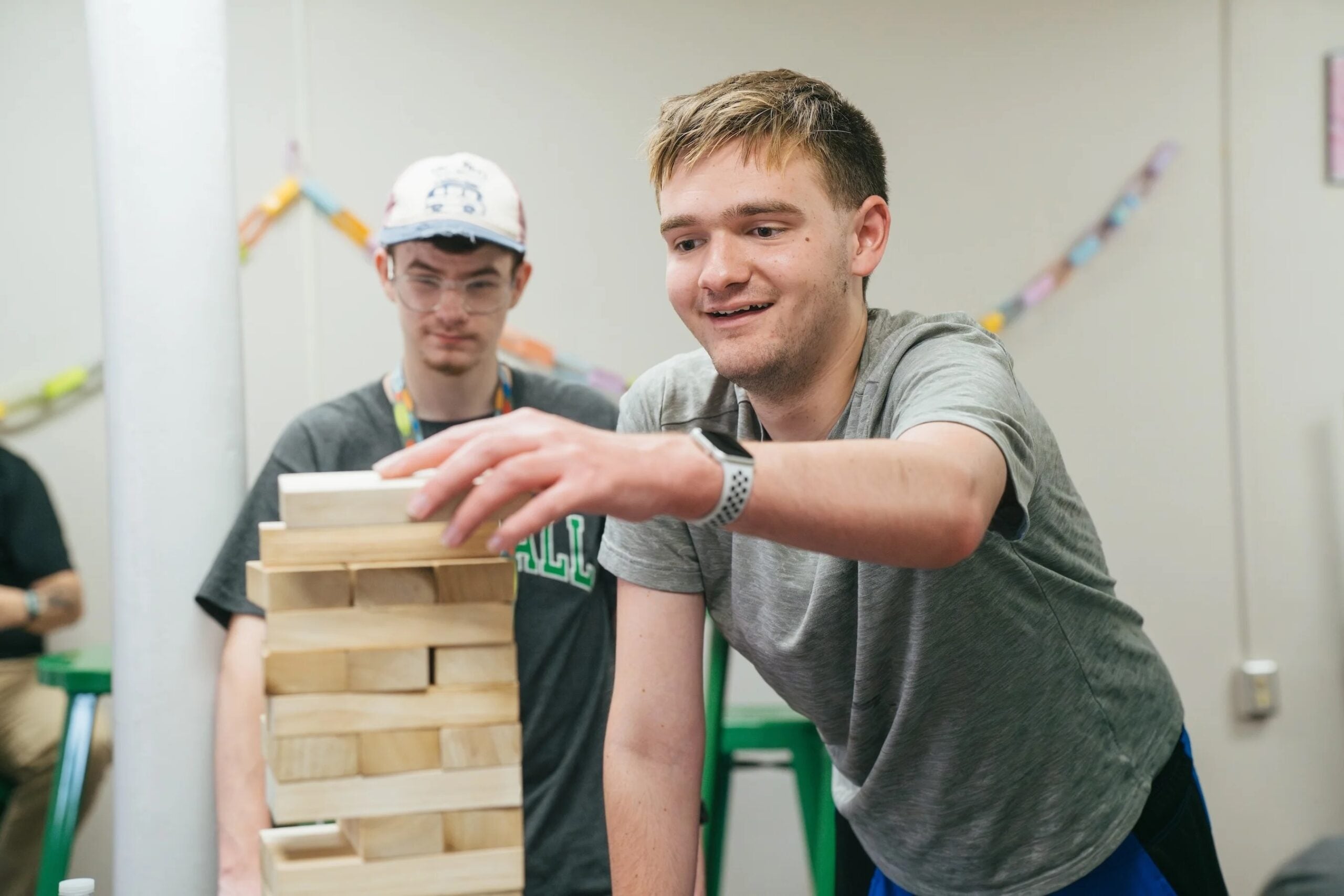 two students playing jenga