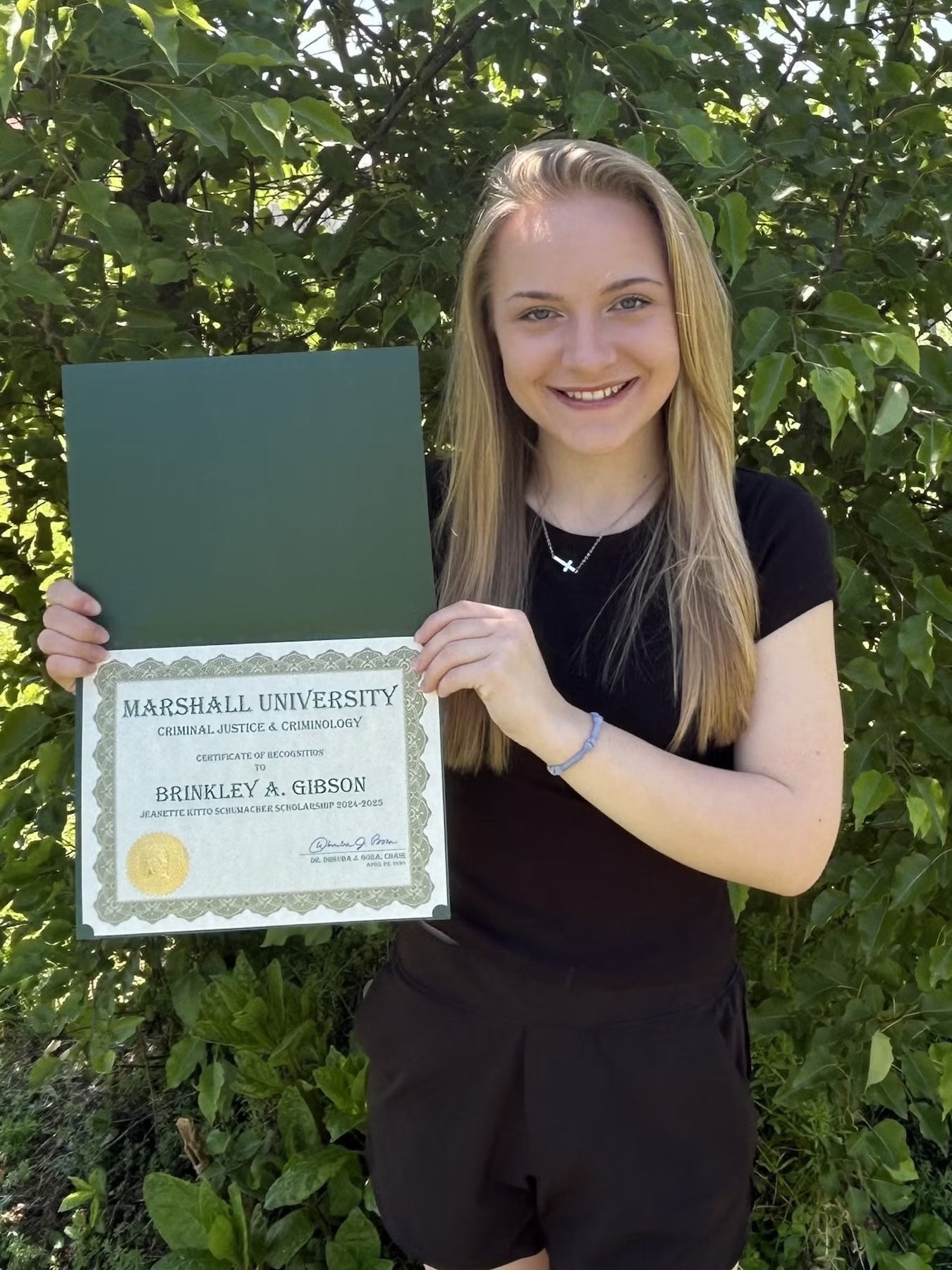 Brinkley Gibson with a certificate