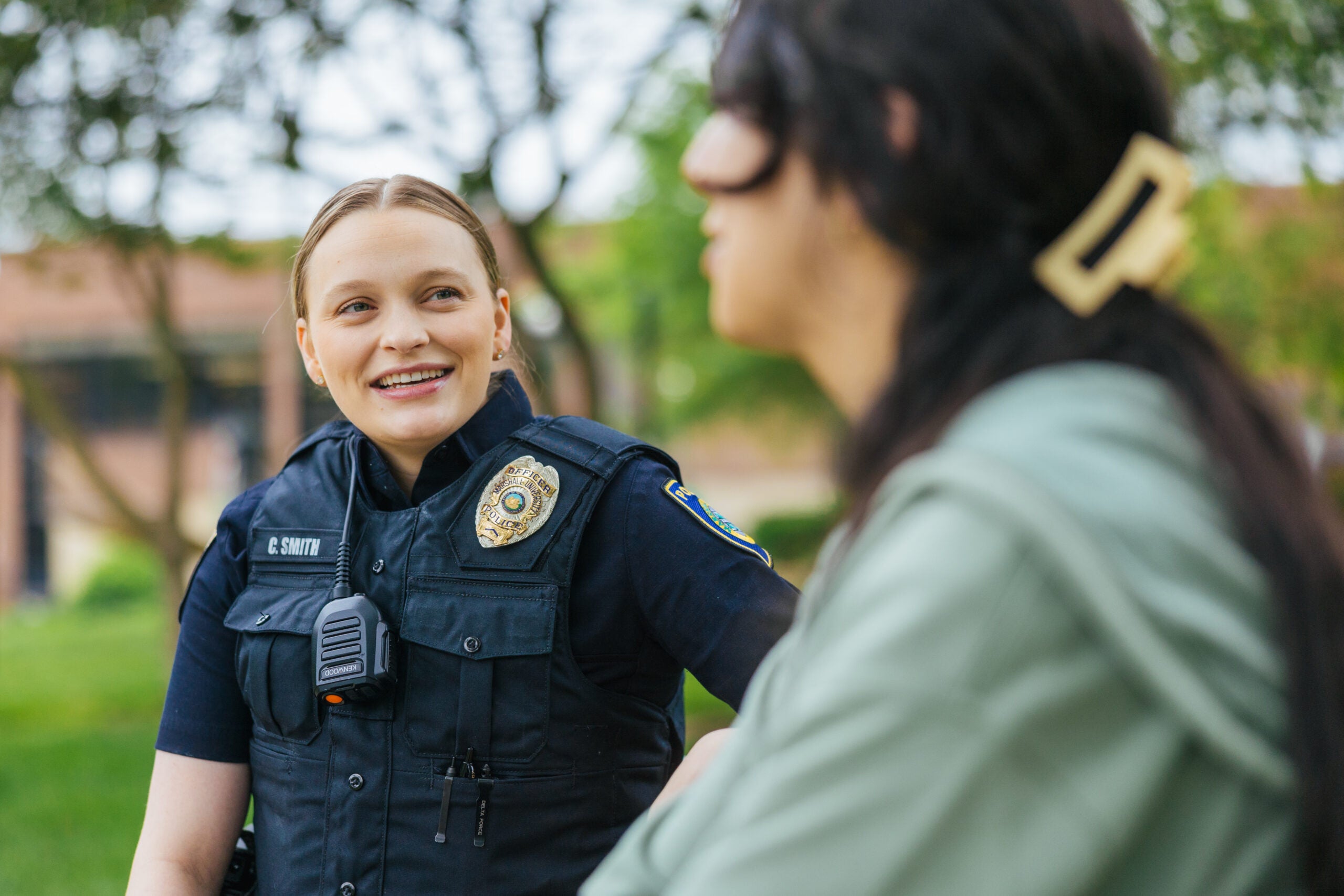 police officer on campus talking to a student