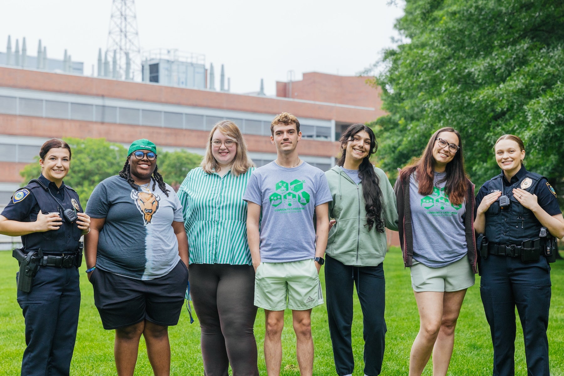 group of students with two marshall police officers smiling at the camera