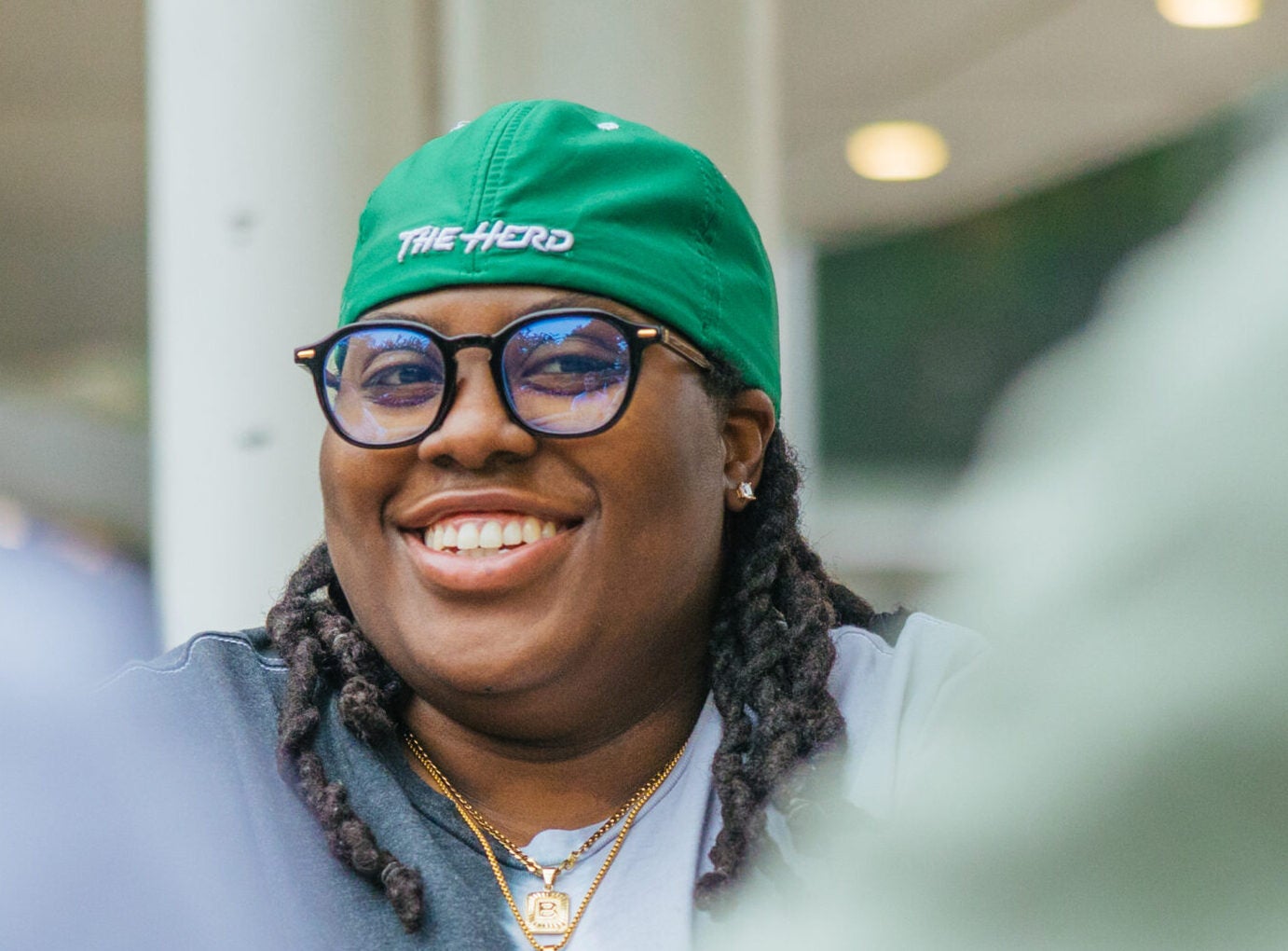 student on campus smiling at the camera