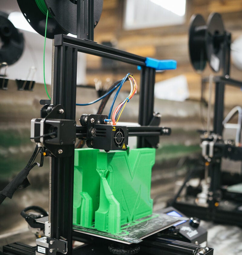 3D printing a Marshall logo at Marshall's Advanced Manufacturing Center