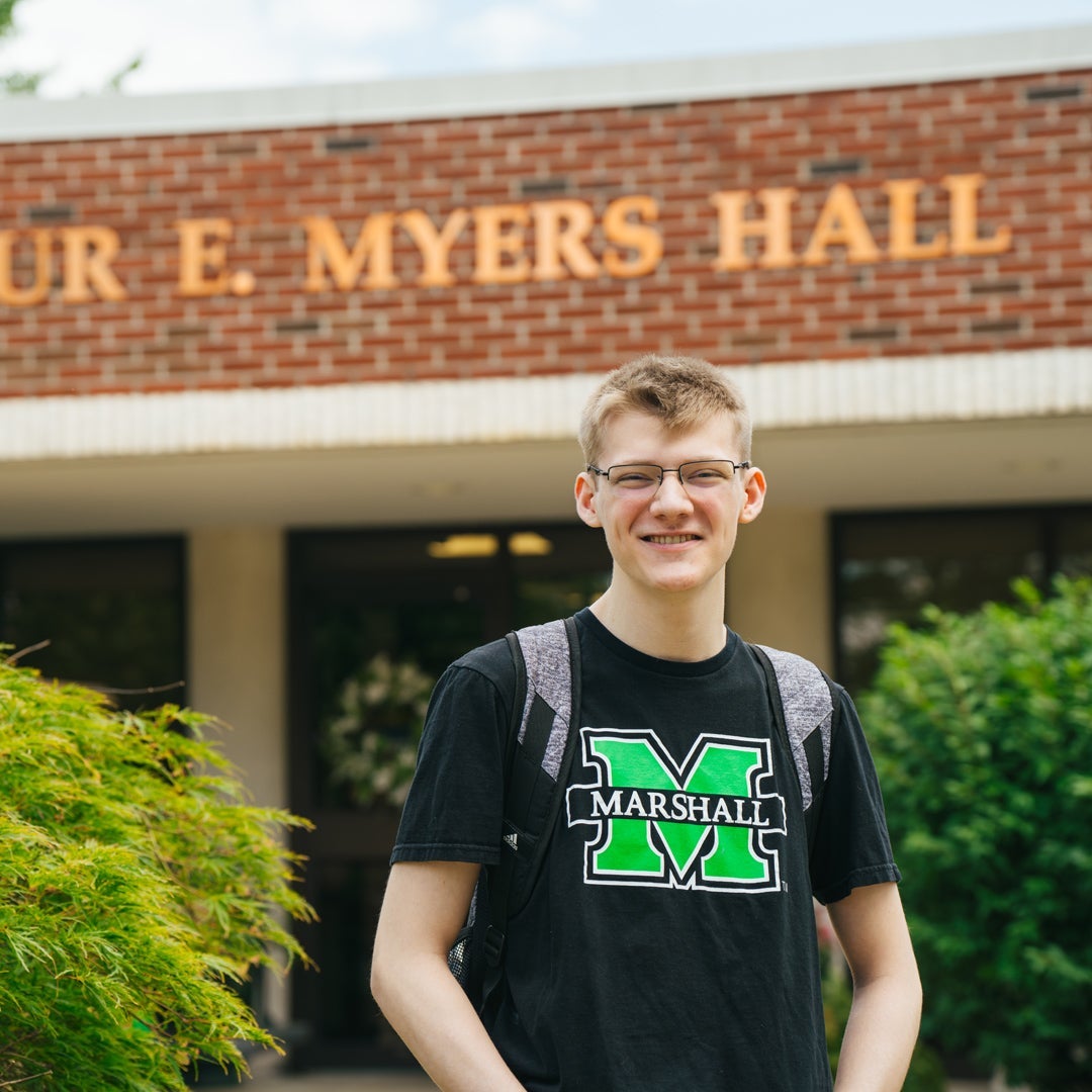 A College HELP student stands outside of the HELP Center at Marshall University