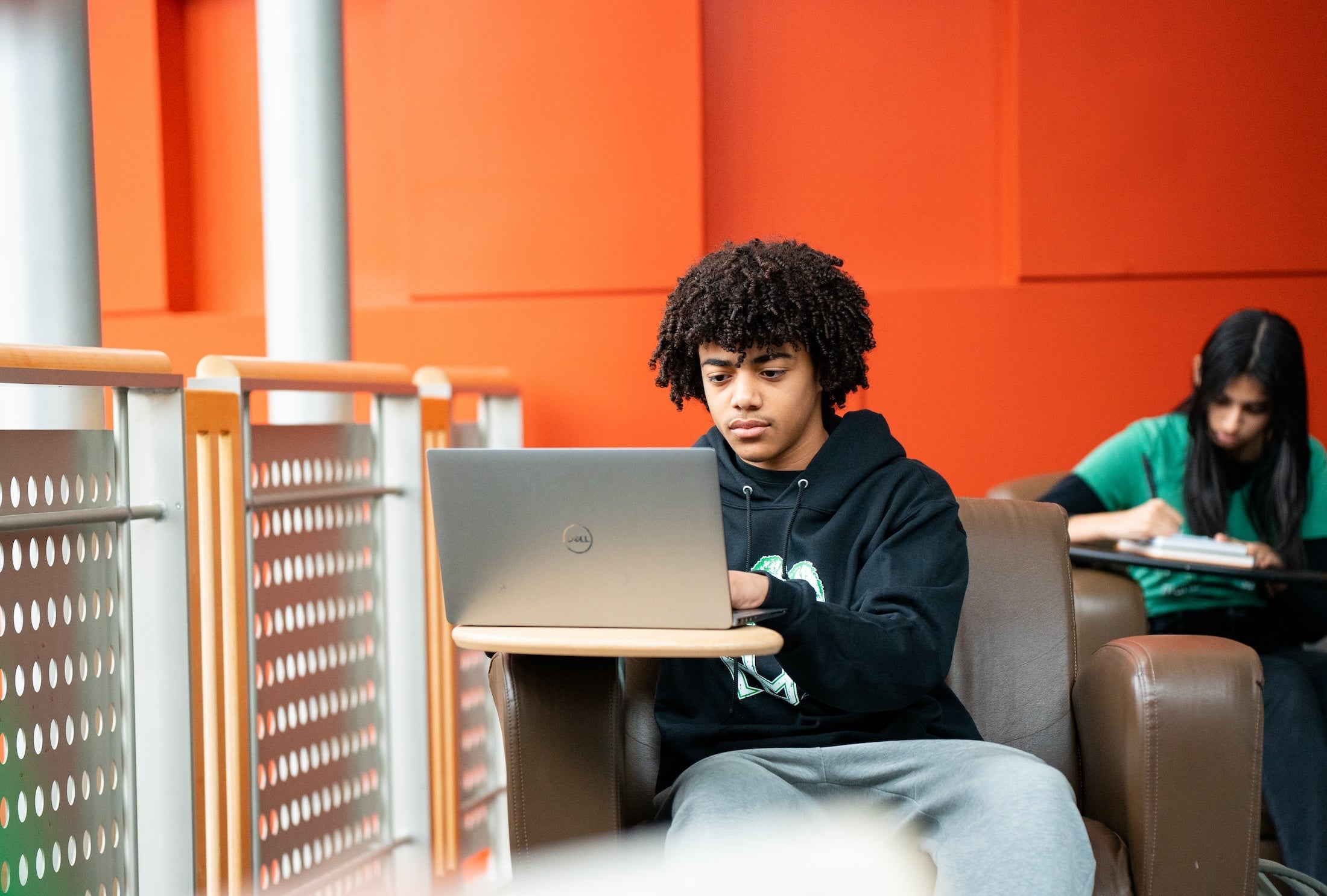 student working on a laptop in the library