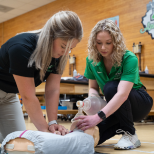 Athletic Training students performing CPR on a manikin.