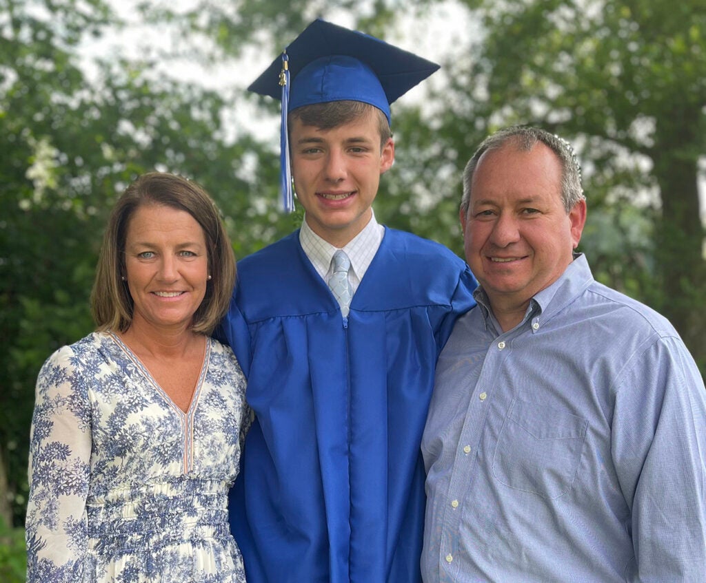 Jimmy John Jacob in his cap and gown with his parents