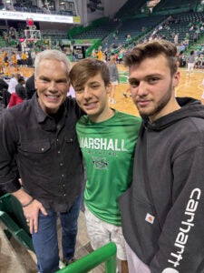 Marshall President Brad D. Smith with students at a basketball