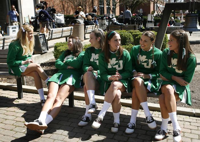 Cheerleaders sit on a bench during the making of We Are Marshall