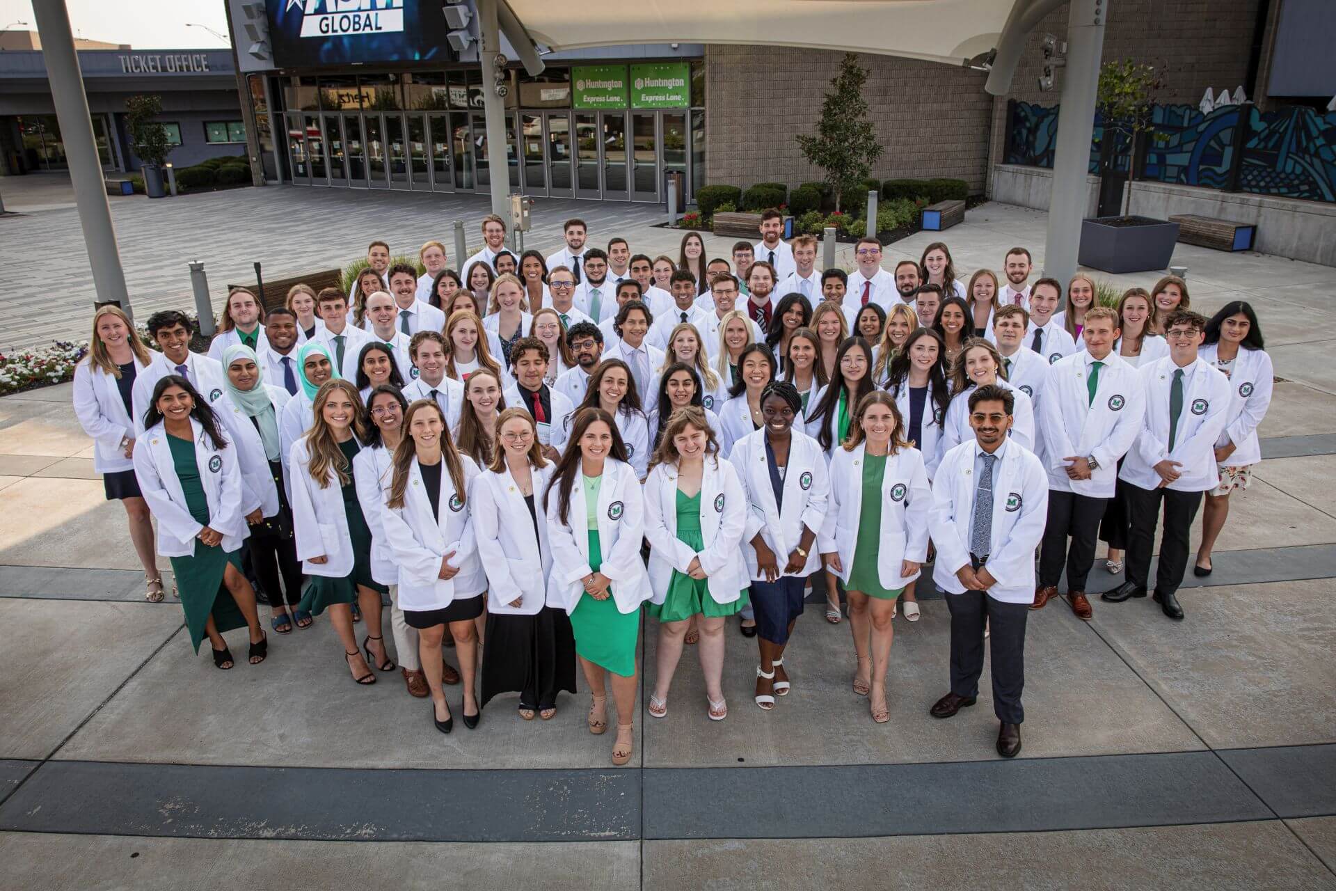 Marshall University Joan C. Edwards School of Medicine's Class of 2028 in their White Coats outside of the Marshall Health Network Arena in downtown Huntington.