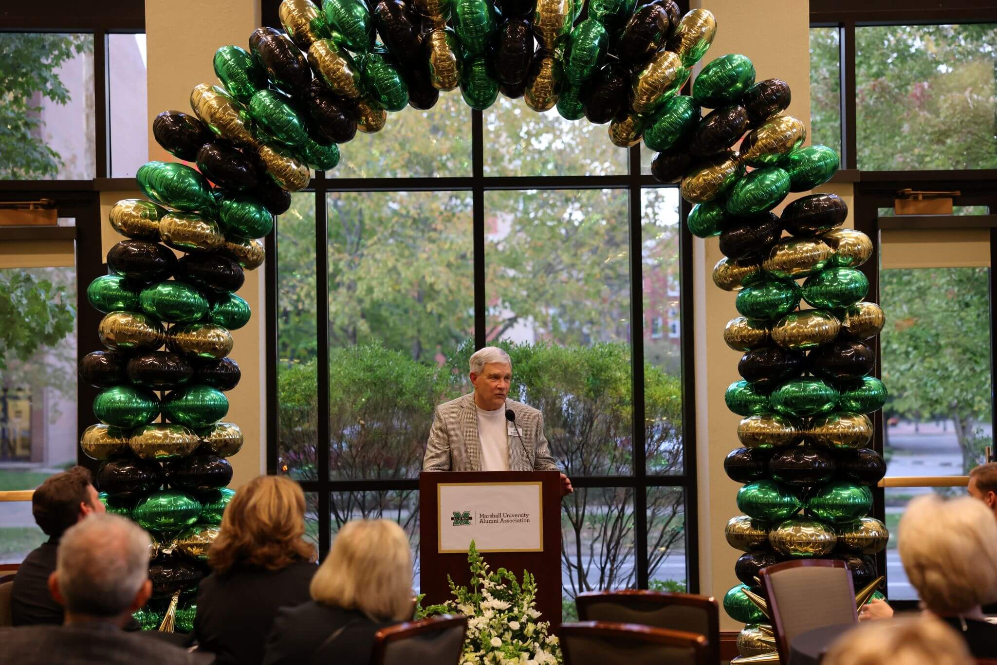 Dr. Ron Area speaking at podium