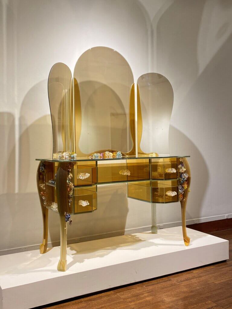 Art exhibit of gold dressing table with mirror