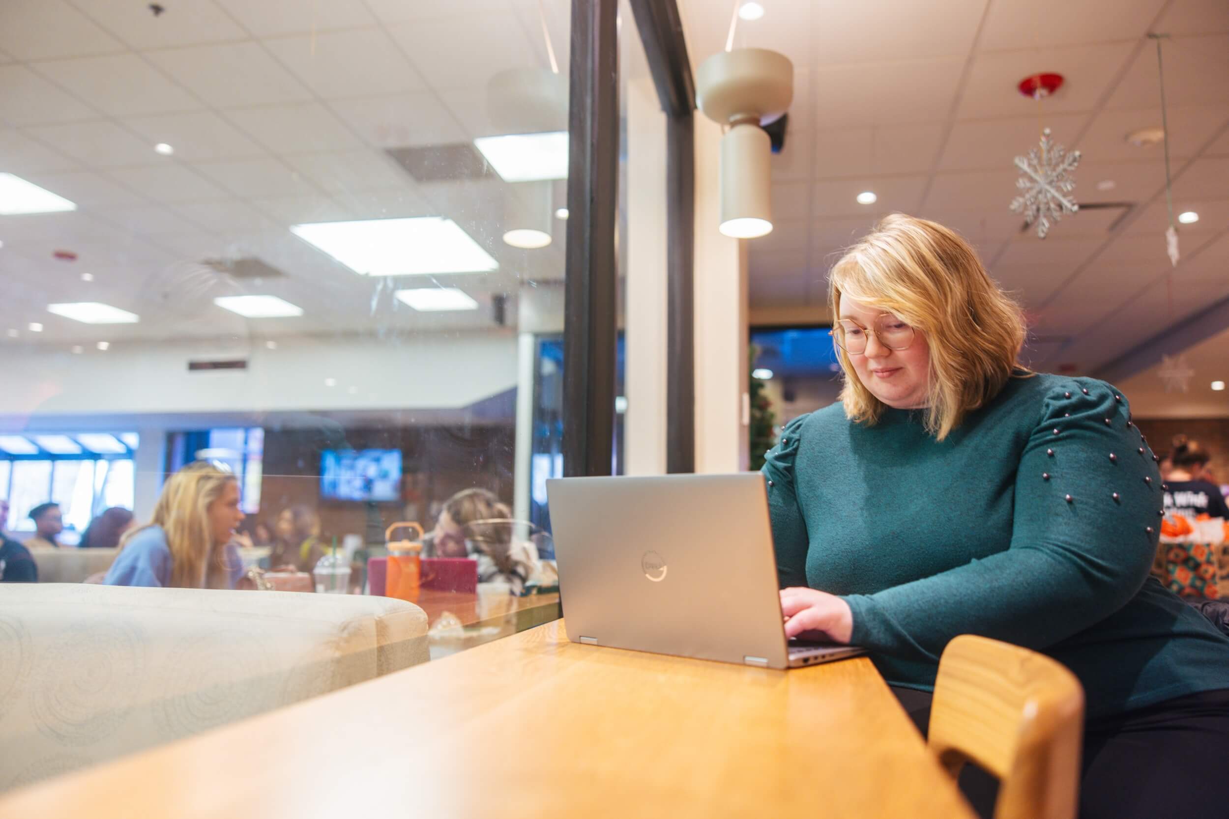 student working on a laptop in Starbucks