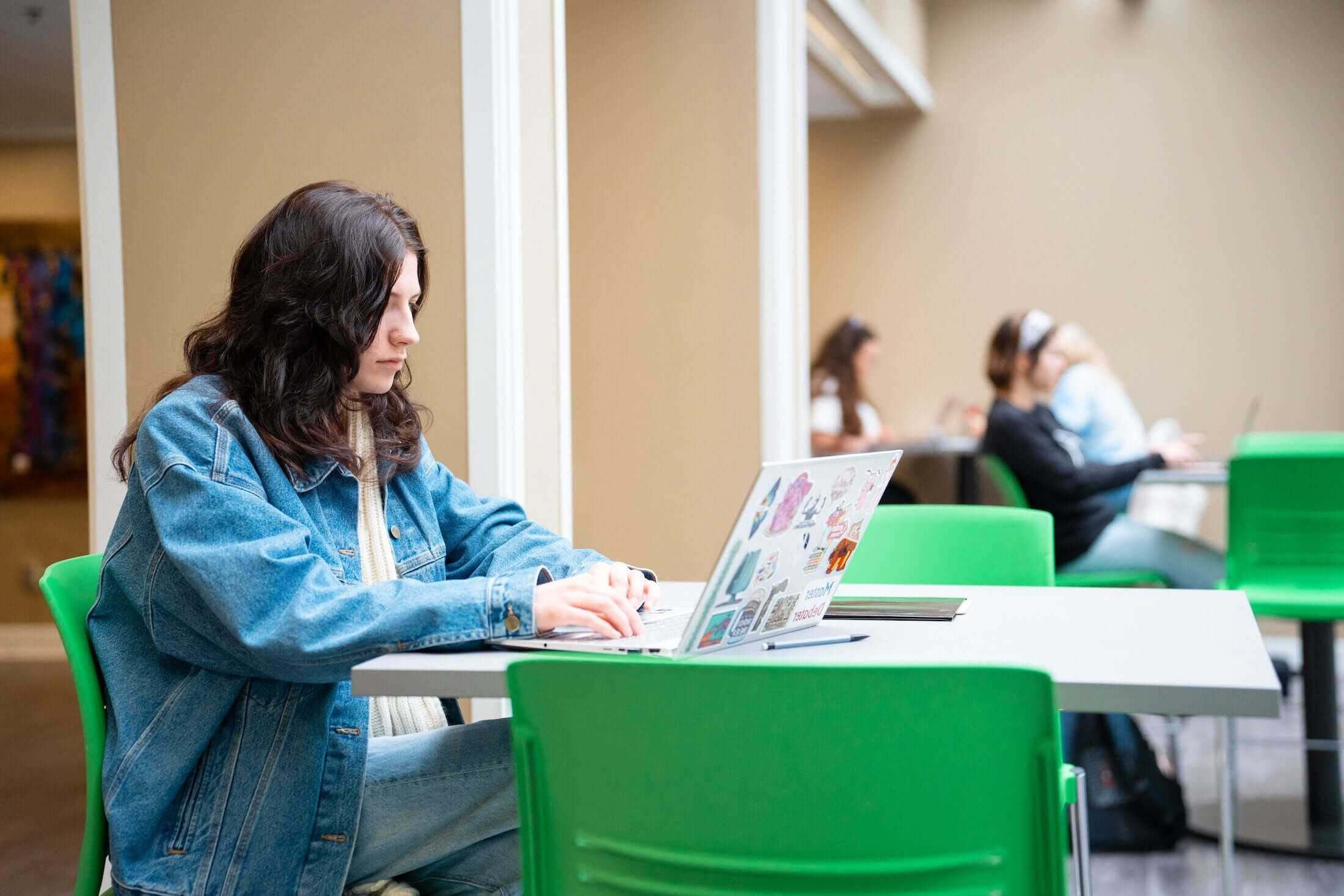 student working on a laptop at a table