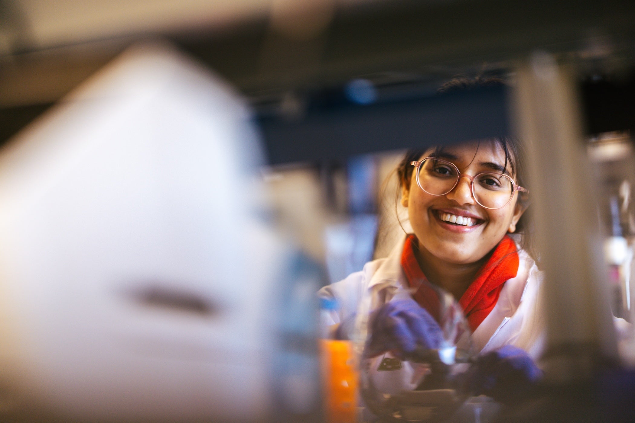 student in glasses in a pharmacy lab