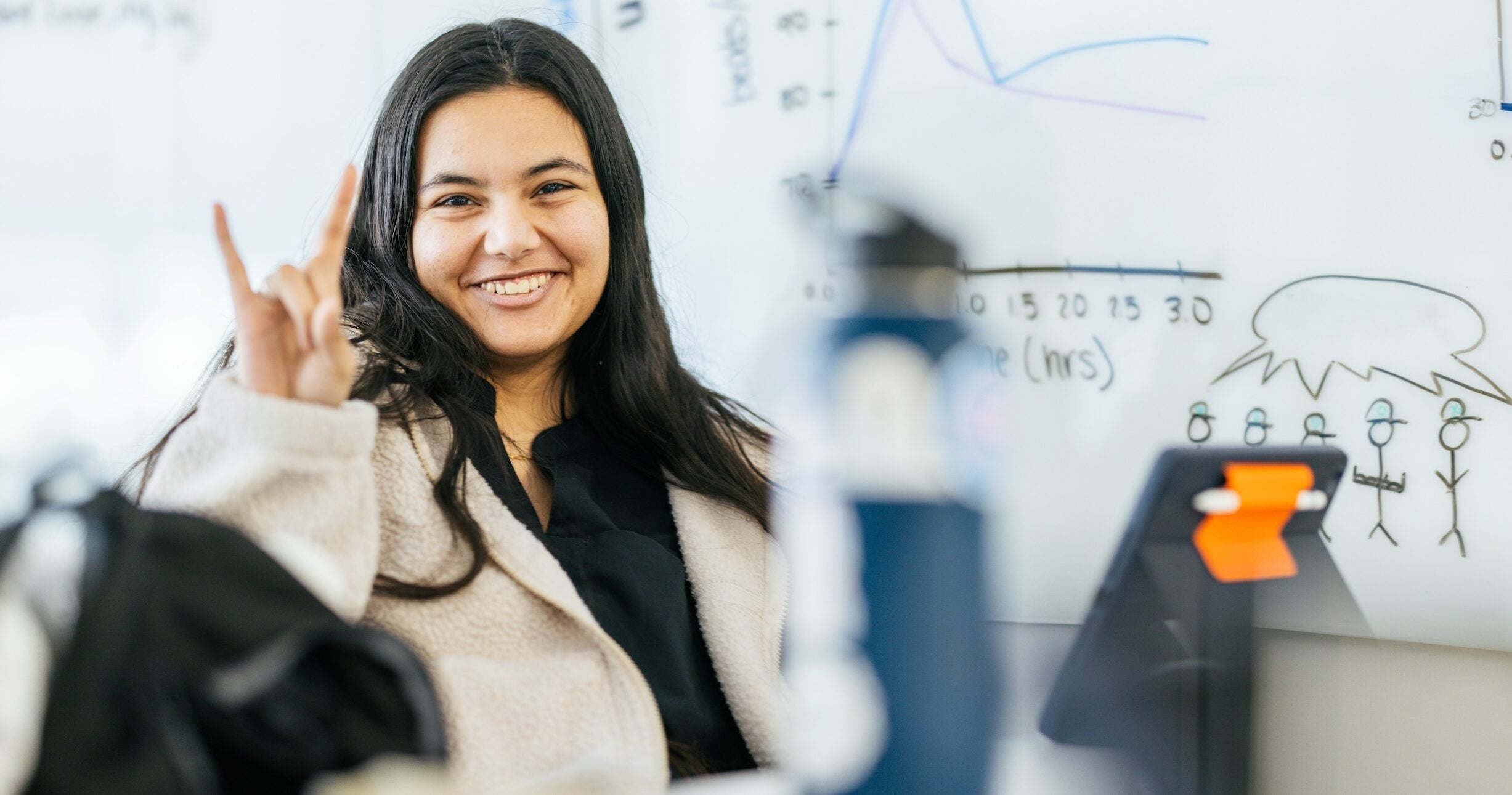 student sitting at a table posing with 