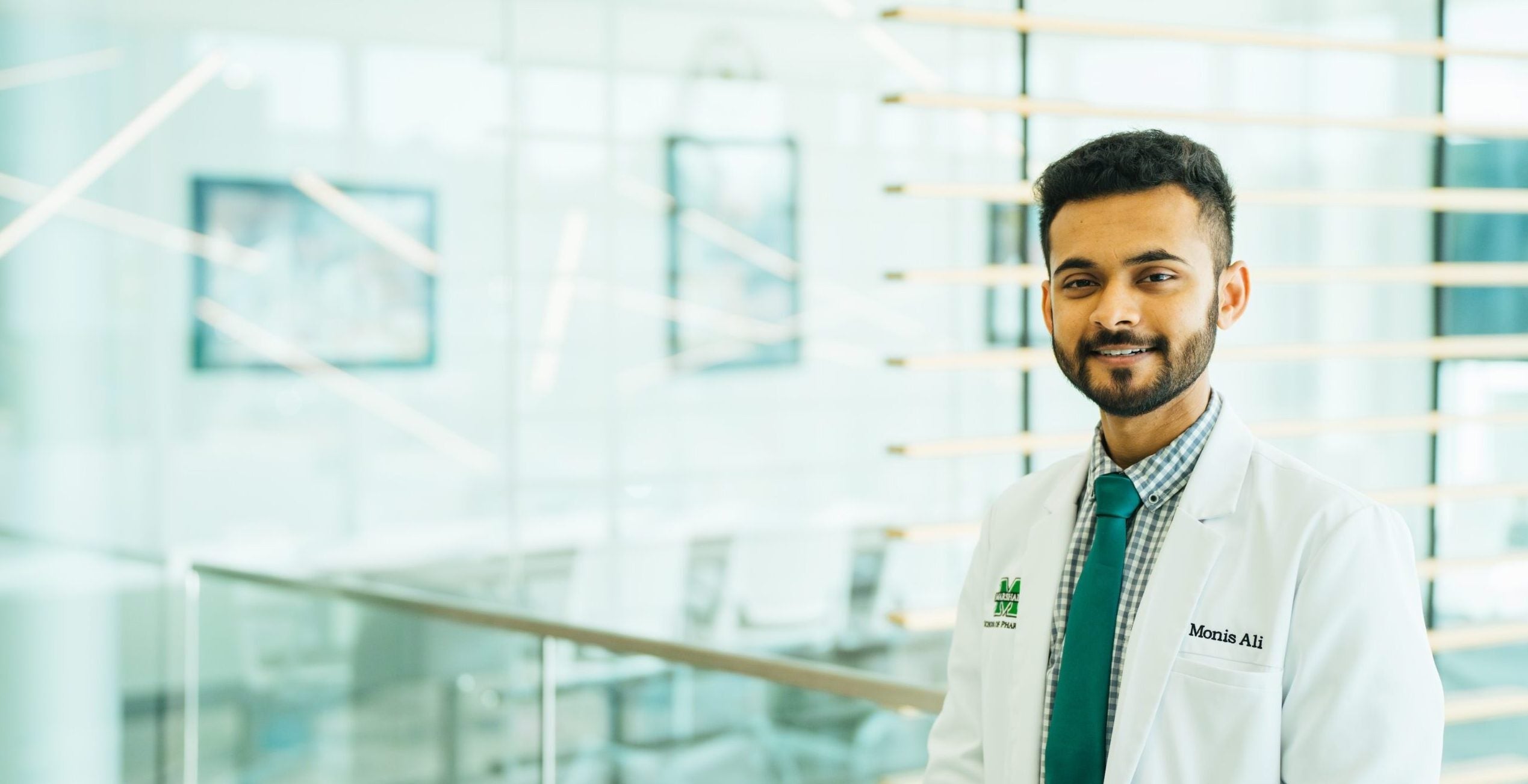 pharmacy student Monis Ali smiling at the camera at school of pharmacy