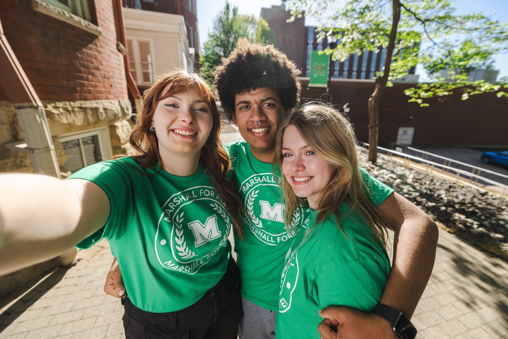 three Marshall For All students taking a selfie on campus