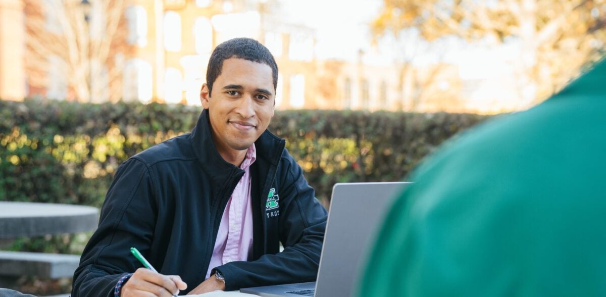 student working on a laptop outside