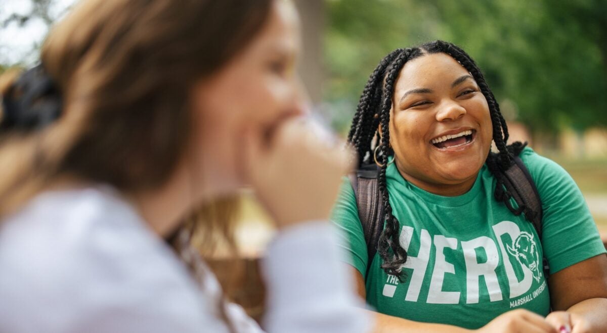 two students laughing outdoors