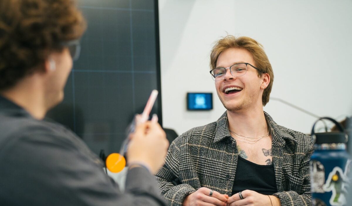 two students talking and laughing