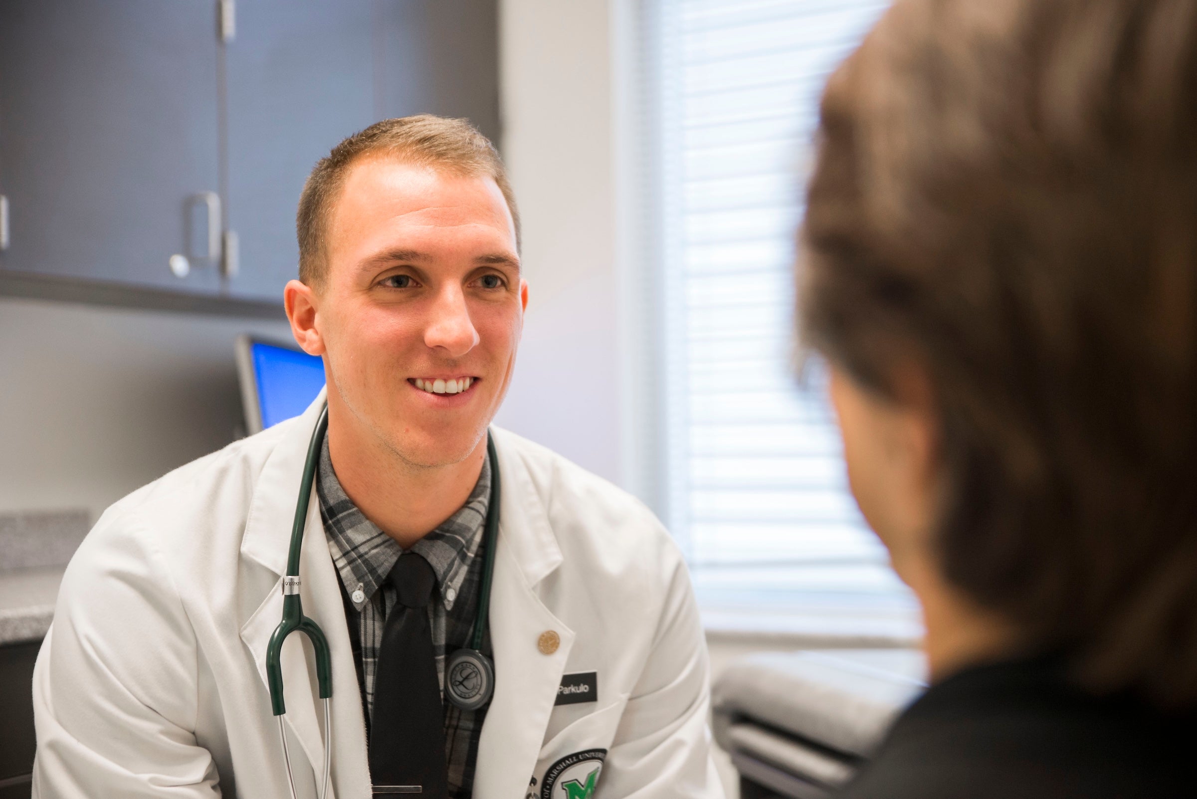 doctor talking to a patient in an exam room