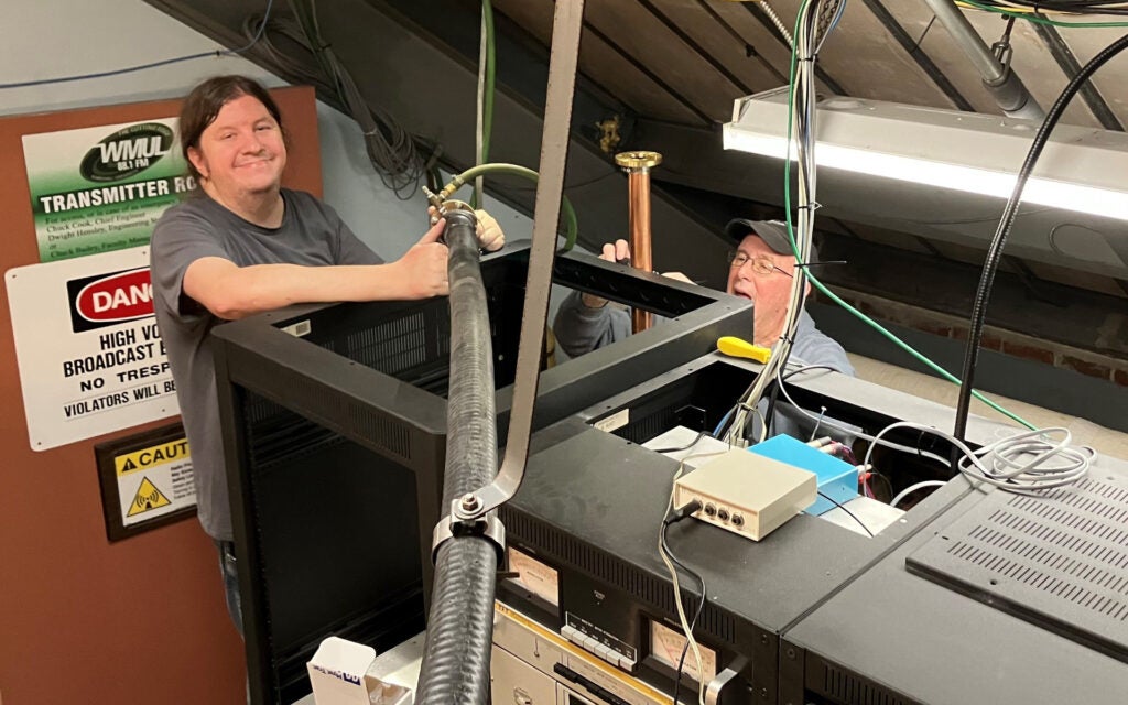 Mike and Dwight connecting the existing transmission line to the new segment.