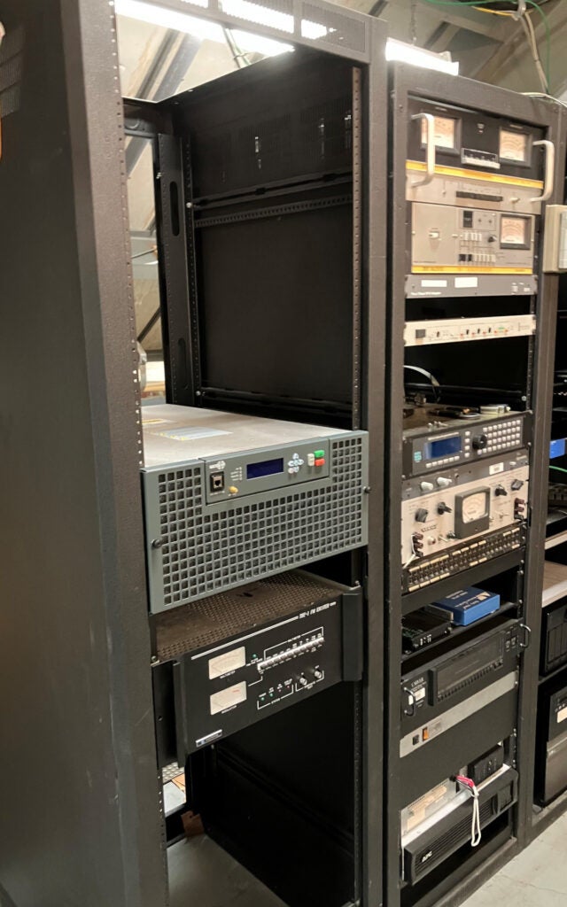 The new transmitter and the old exciter sit in the equipment rack.