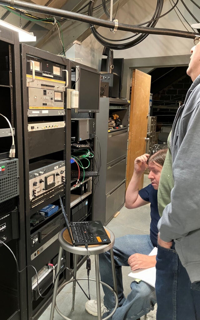 Mike adjusts the new transmitter using the laptop while Dwight reads the Modulation Monitor.