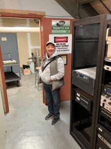 Missy stands in front of the new transmitter.